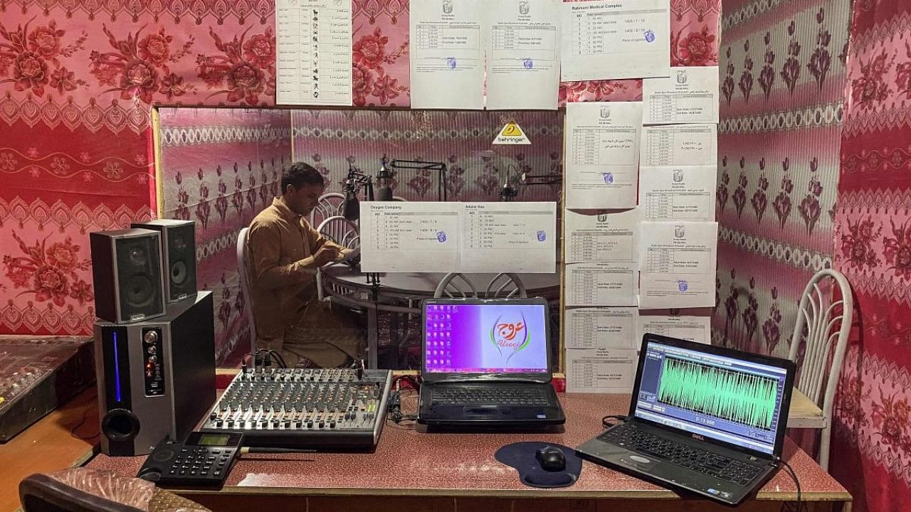Radio station Urooj once teamed with journalists producing news bulletins, but since the Taliban came to town, Ebrahim Parhar sits alone, broadcasting hours of religious sermons. Credit: AFP Photo