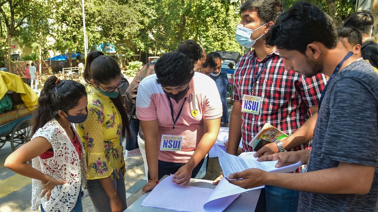 Students enquire at a help desk outside Arts Faculty, during Delhi University undergraduate courses admission in New Delhi. Credit: PTI File Photo