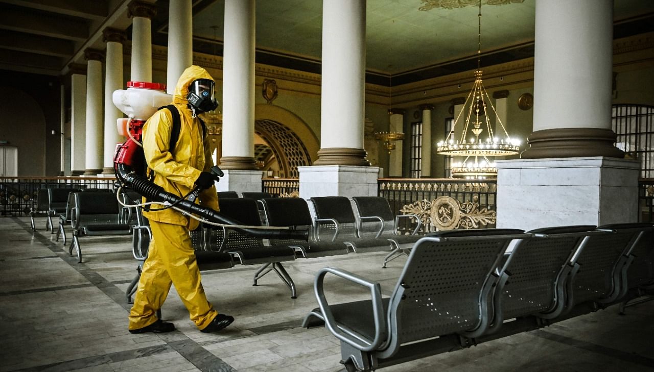 A serviceman of Russia's Emergencies Ministry, wearing protective gear, disinfects Kievsky railway terminal amid the Covid-19 pandemic in Moscow. Credit: AFP File Photo