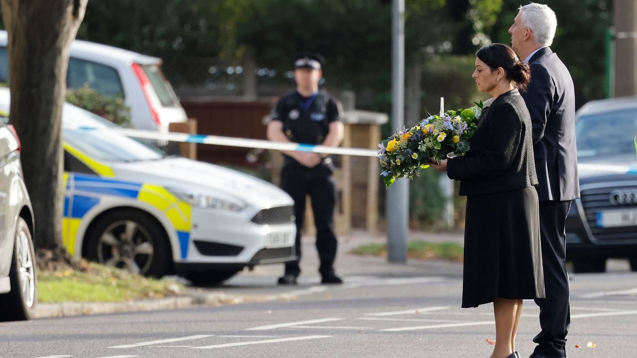 Britain's Home Secretary Priti Patel (L) and Speaker of the House Lindsay Hoyle lay floral tributes at the scene of the fatal stabbing. Credit: AFP Photo