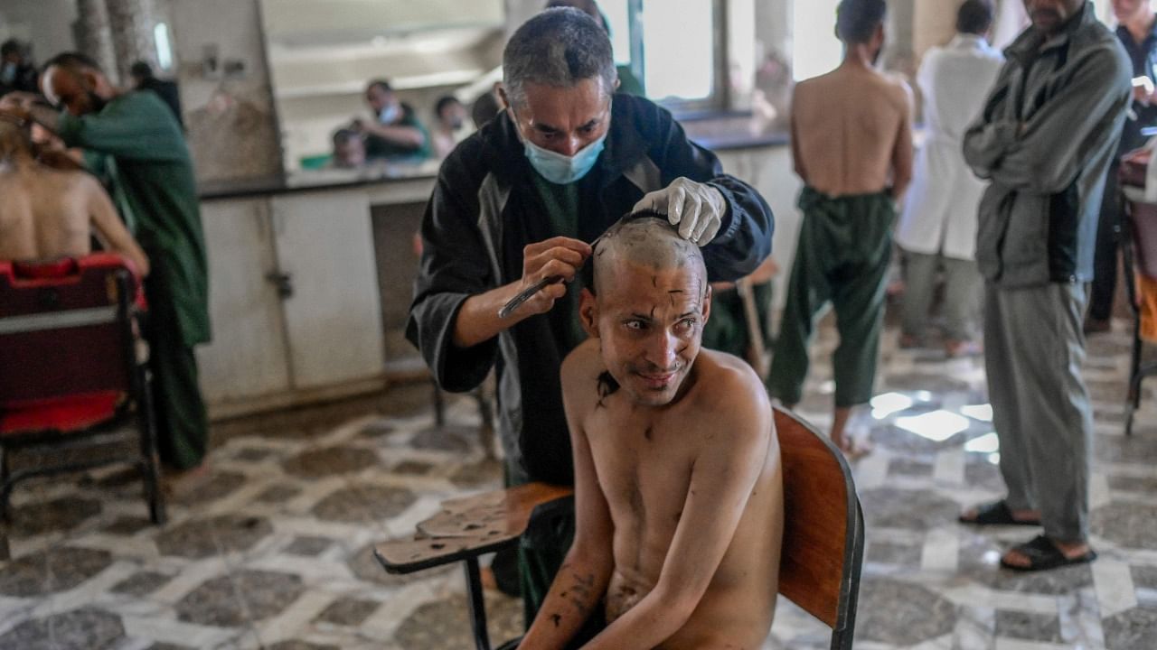 This file photo shows a drug addict getting his head shaved at a detoxification ward of the Avicenna Medical Hospital for Drug Treatment in Kabul. Credit: AFP Photo