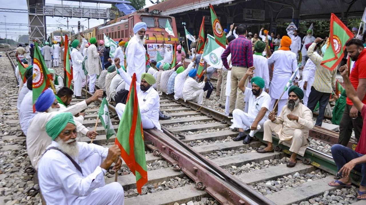  Members of various farmers organizations black railway tracks during a protest against central government, in Patiala. Credit: PTI Photo