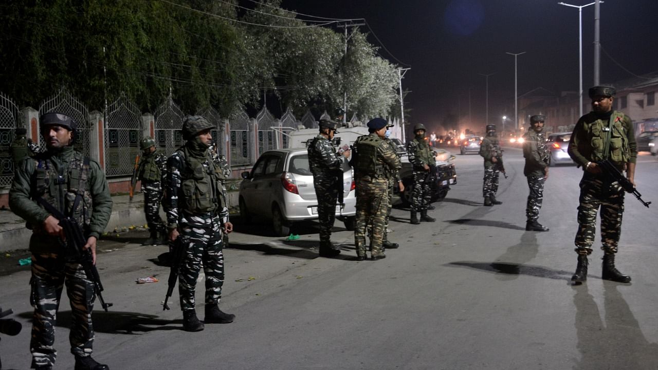 Security forces inspect the spot where militants shot dead a civilian in Srinagar. Credit: PTI File Photo