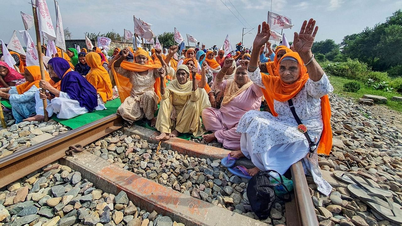 Farmers block railway tracks as part of the Samyukt Kisan Morcha's 'rail roko' protest. Credit: PTI Photo