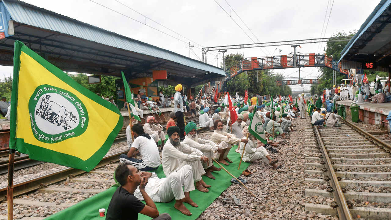 Farmers block railway tracks as part of the Samyukt Kisan Morcha's 'Rail Roko' in Bahadurgarh. Credit: PTI Photo