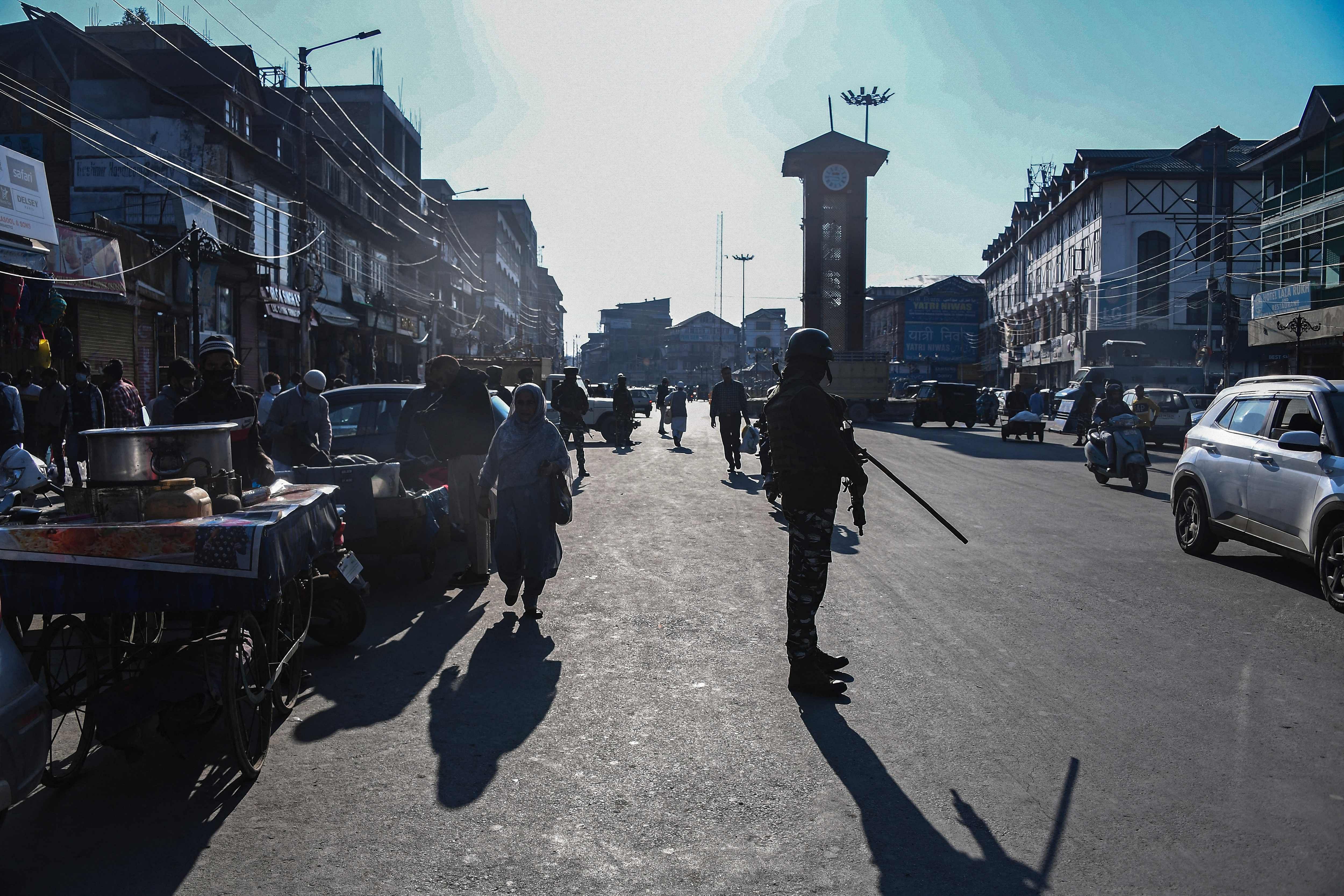 A security personnel stands guard along a street in Srinagar. Credit: AFP Photo