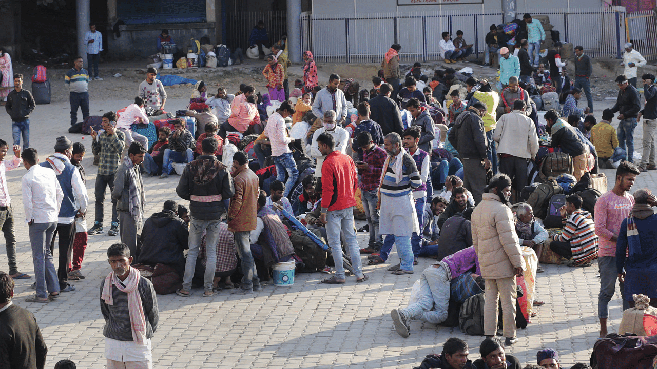 Migrant labourers arrive at a railway station, as they plan to leave the state, in Jammu. Credit: PTI Photo