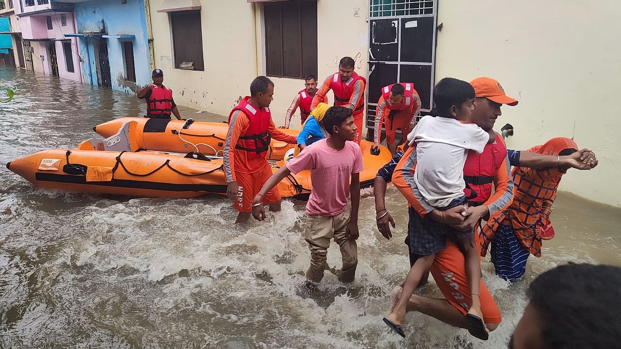 National Disaster Response Force (NDRF) personnel rescue people stranded in floodwaters in Udham Singh Nagar, Uttarakhand, Tuesday. Credit: PTI Photo