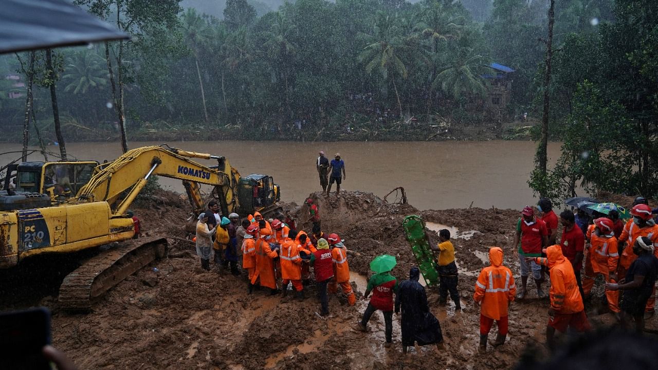 Rescue workers carry the body of a victim after recovering it from the debris of a residential house following a landslide caused by heavy rainfall at Kokkayar village in Idukki district. Credit: Reuters File Photo