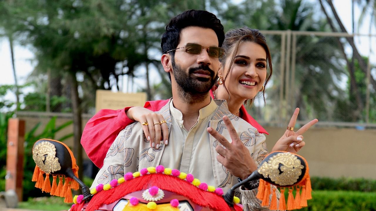 Bollywood actors Rajkummar Rao and Kriti Sanon (R) pose for pictures during the promotion of their upcoming comedy drama Hindi film 'Hum Do Hamare Do' in Mumbai on October 19, 2021. Credit: AFP Photo