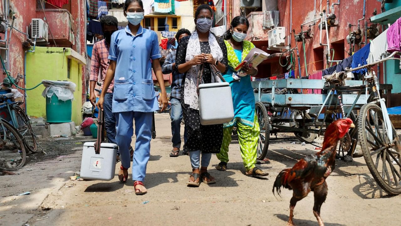 Health workers during a door-to-door Covid-19 vaccination campaign at a residential area in Chennai. Credit: PTI Photo