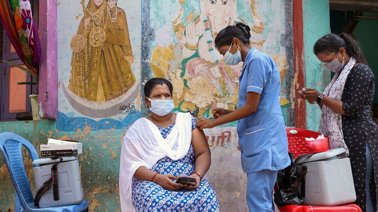 A health worker inoculates a beneficiary with the dose of Covishield vaccine against the coronavirus during a door-to-door vaccination campaign at a residential area in Chennai, Wednesday, October 20, 2021. Credit: PTI Photo