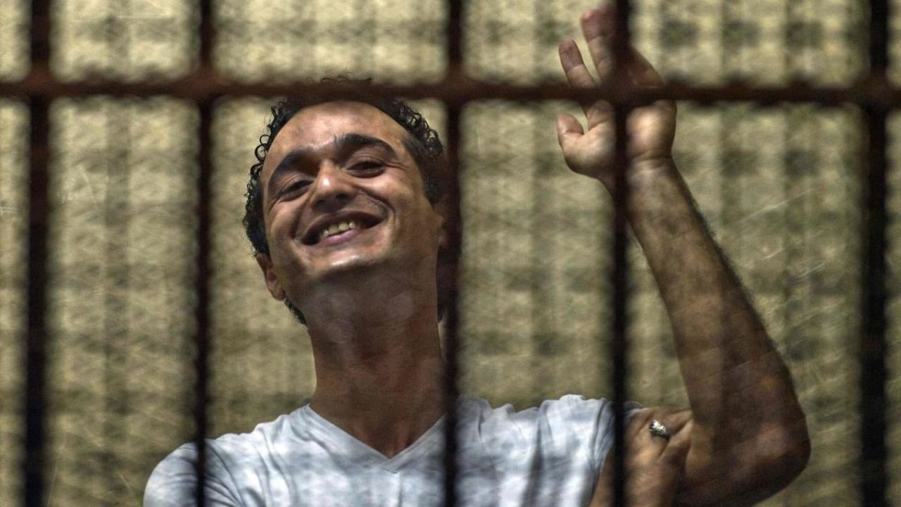 In this file photo taken on June 3, 2013, Egyptian political activist Ahmed Douma reacts as he stands behind dock bars during his trial in the capital Cairo. Credit: AFP File Photo