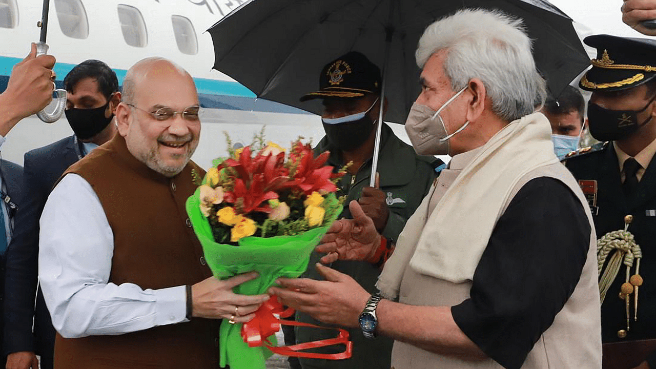 Union Home Minister Amit Shah being received by LG of J&K Manoj Sinha on his arrival in Srinagar. Credit: PTI Photo