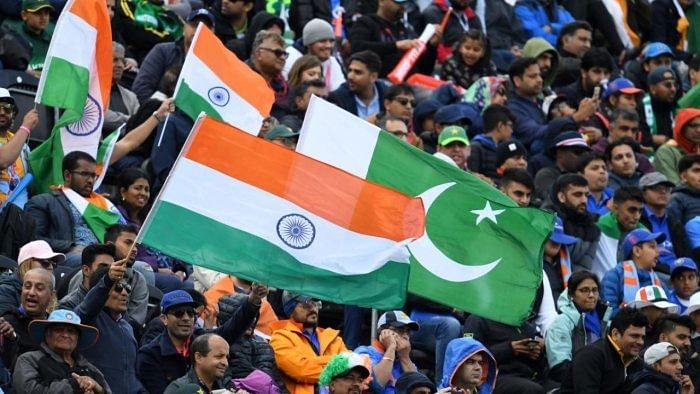 Spectators wave flags during the 2019 Cricket World Cup group stage match between India and Pakistan. Credit: AFP Photo