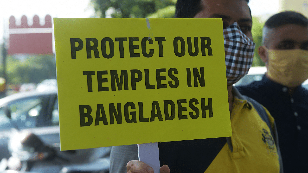 Demonstrators hold placards during a protest organised by International Society for Krishna Consciousness. Credit AFP Photo