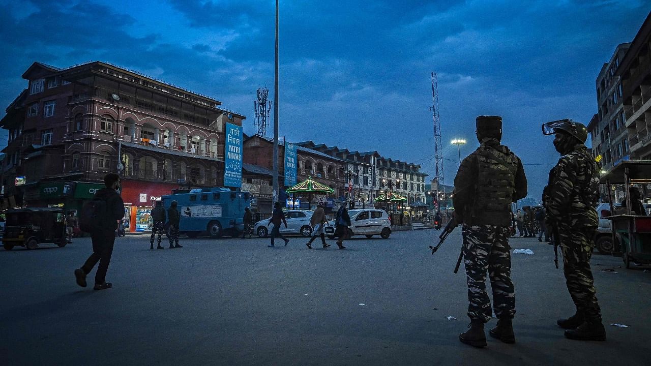 An Indian paramilitary trooper stands guard along a street ahead of the visit of India's Home Minister Amit Shah, in Srinagar on October 22, 2021. Credit: AFP Photo