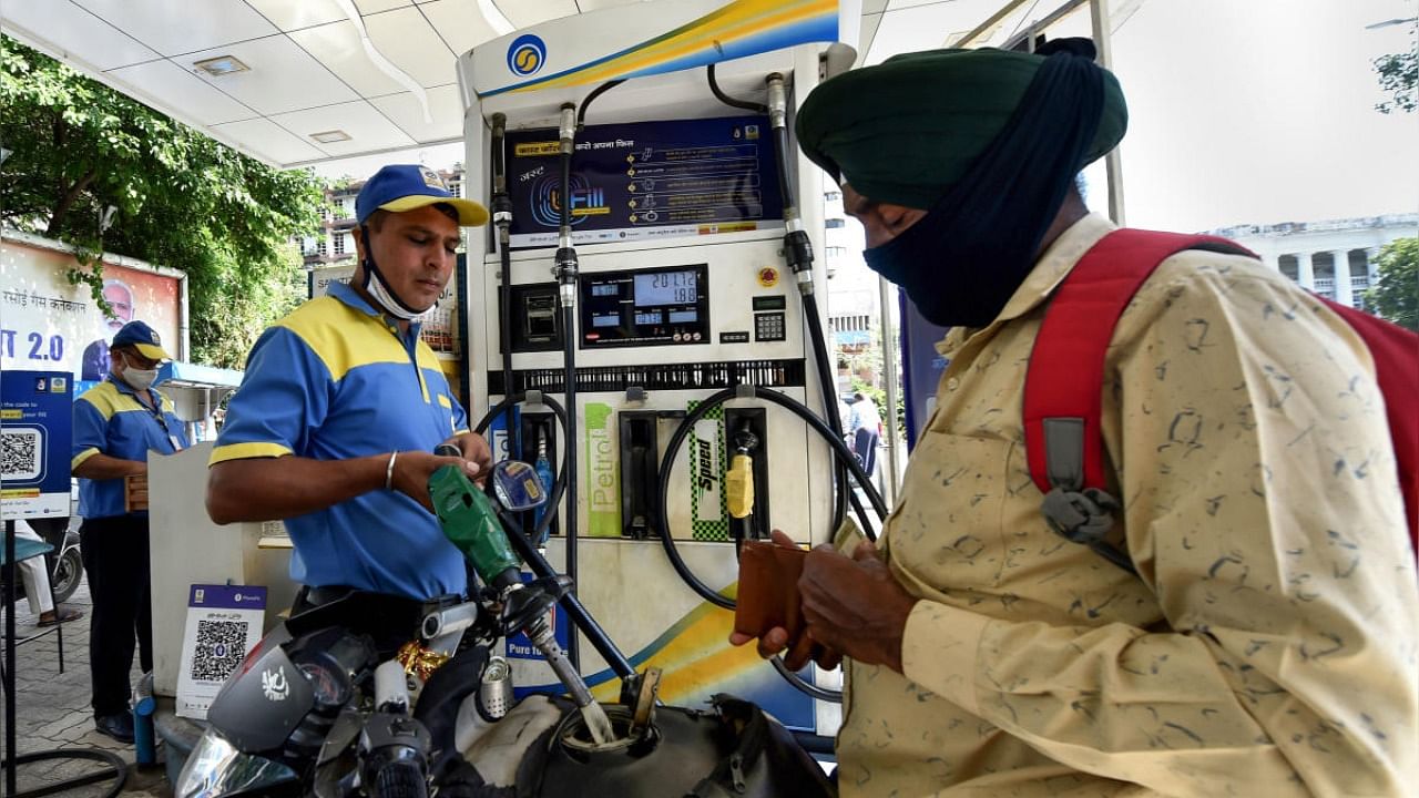  A pump attendant fills petrol in a vehicle at a refilling station as petrol prices soar across the country. Credit: PTI Photo