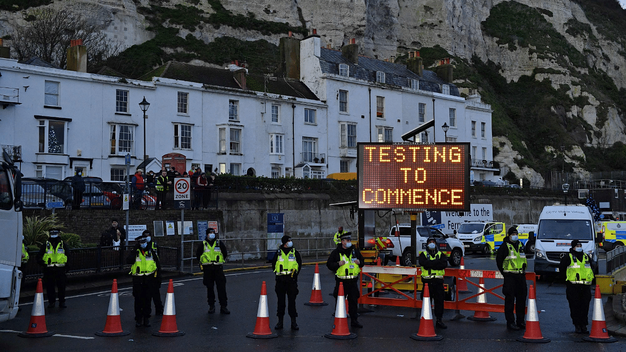 Police officers stand on duty at beneath a sign reading "Testing to Commence", at the entrance to the Port of Dover in Kent, south east England. Credit: AFP Photo