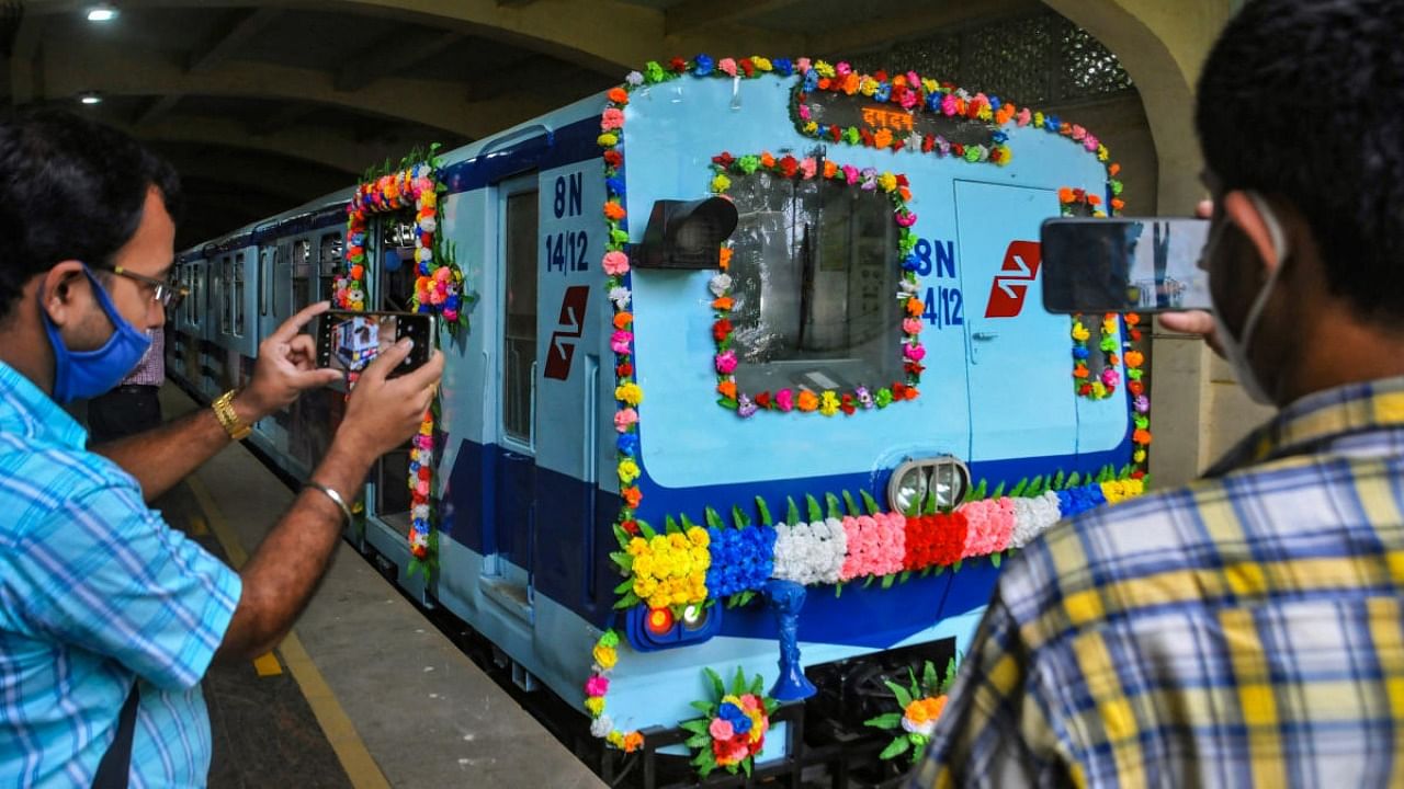 Metro staff take pictures of a metro coach during the farewell ceremony of 'Non-AC Metro rakes' on the occasion of 37th foundation Day of Metro Railway, in Kolkata. Credit: PTI file photo