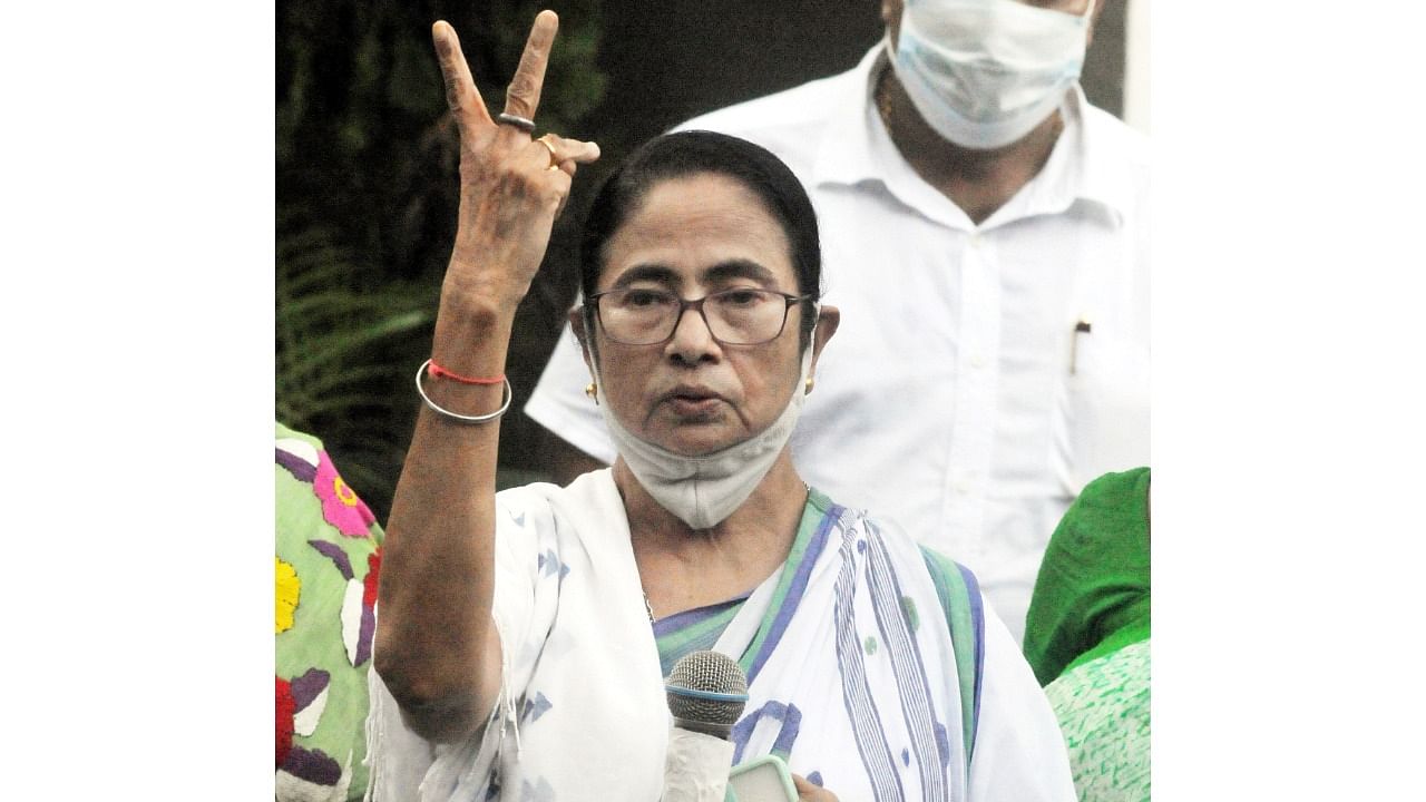 West Bengal Chief Minister Mamata Banerjee flashes victory sign as she leads in Bhawanipur Assembly by-polls in Kolkata. Credit: PTI File Photo