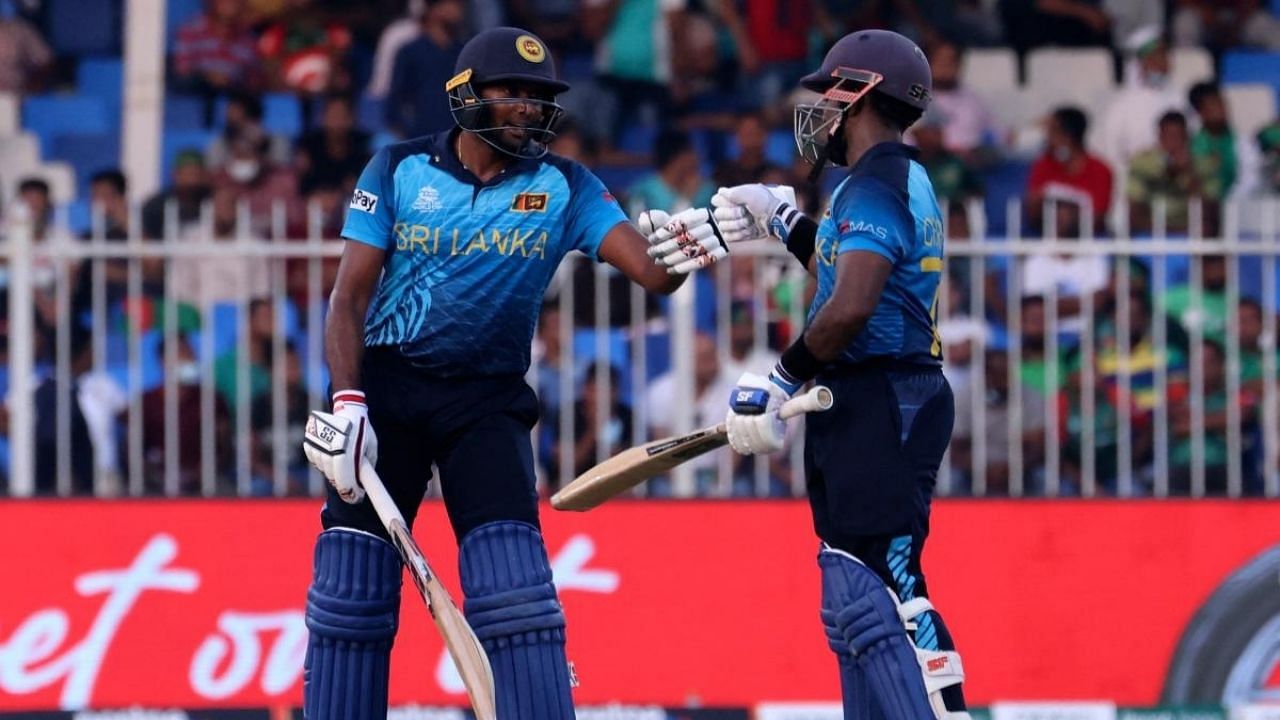 Sri Lanka's Bhanuka Rajapaksa (L) and his teammate Charith Asalanka bump their fists during the ICC men’s Twenty20 World Cup cricket match. Credit: AFP Photo