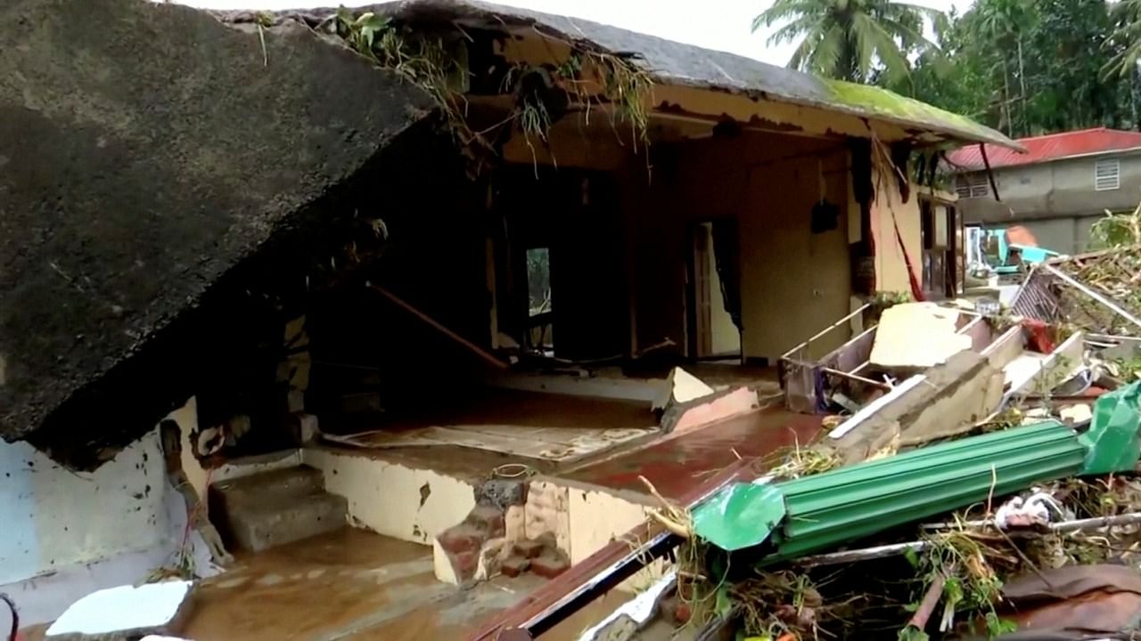 A general view of a house damaged in the heavy rains received in Kottayam, Kerala, India, October 17, 2021, in this still image taken from video on October 18, 2021. Credit: Reuters TV/ANI/Kerala Government PRO