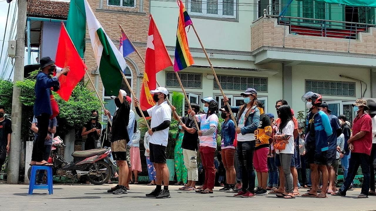 Demonstrators carry flags during a protest against the military coup, in Dawei, Myanmar. Credit: Reuters File Photo