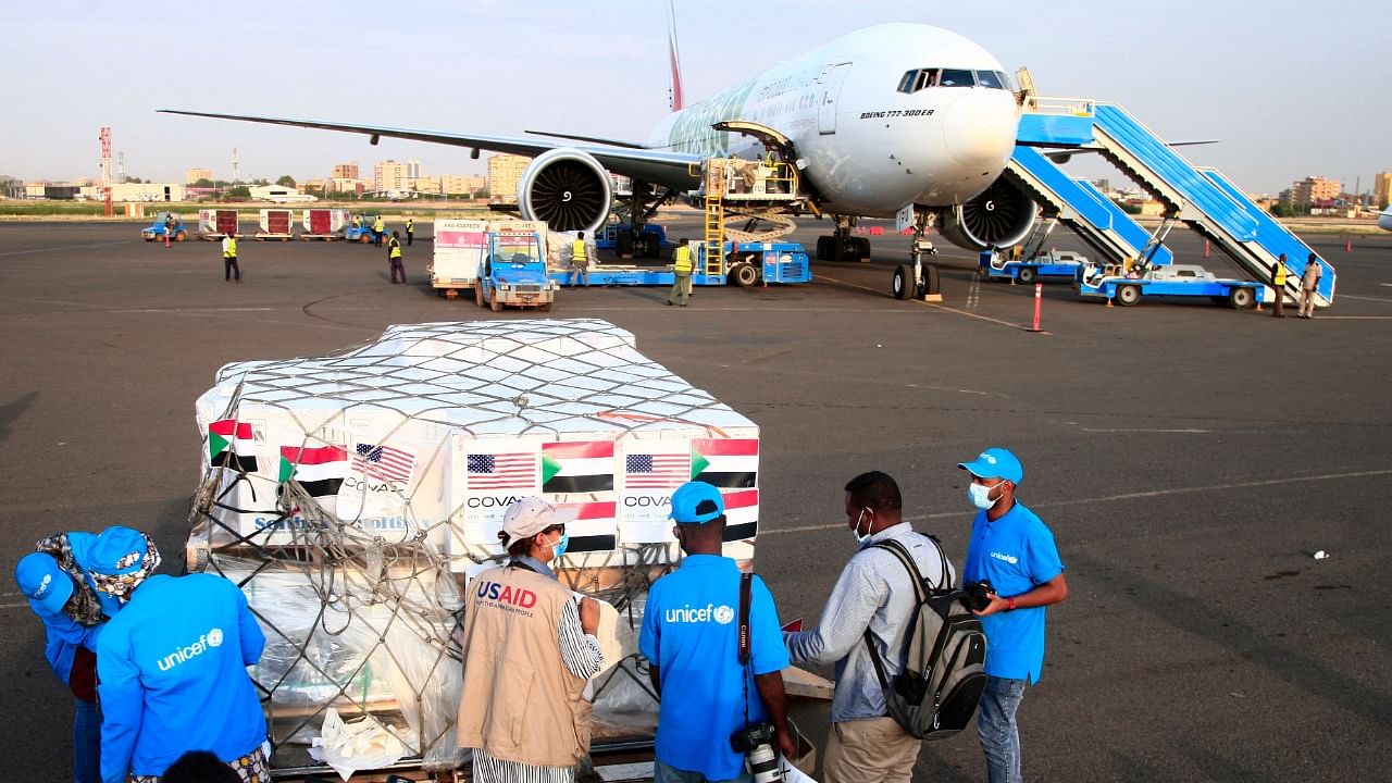 Aid workers check a shipment of vaccines against the coronavirus sent to Sudan by the Covax vaccine-sharing initiative at the airport in the capital Khartoum. Credit: AFP File Photo