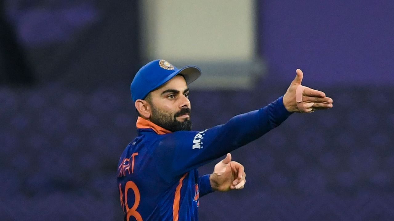 India's captain Virat Kohli adjusts the fielding positions during the ICC men’s Twenty20 World Cup cricket match between India and Pakistan at the Dubai International Cricket Stadium in Dubai on October 24, 2021. Credit: AFP Photo