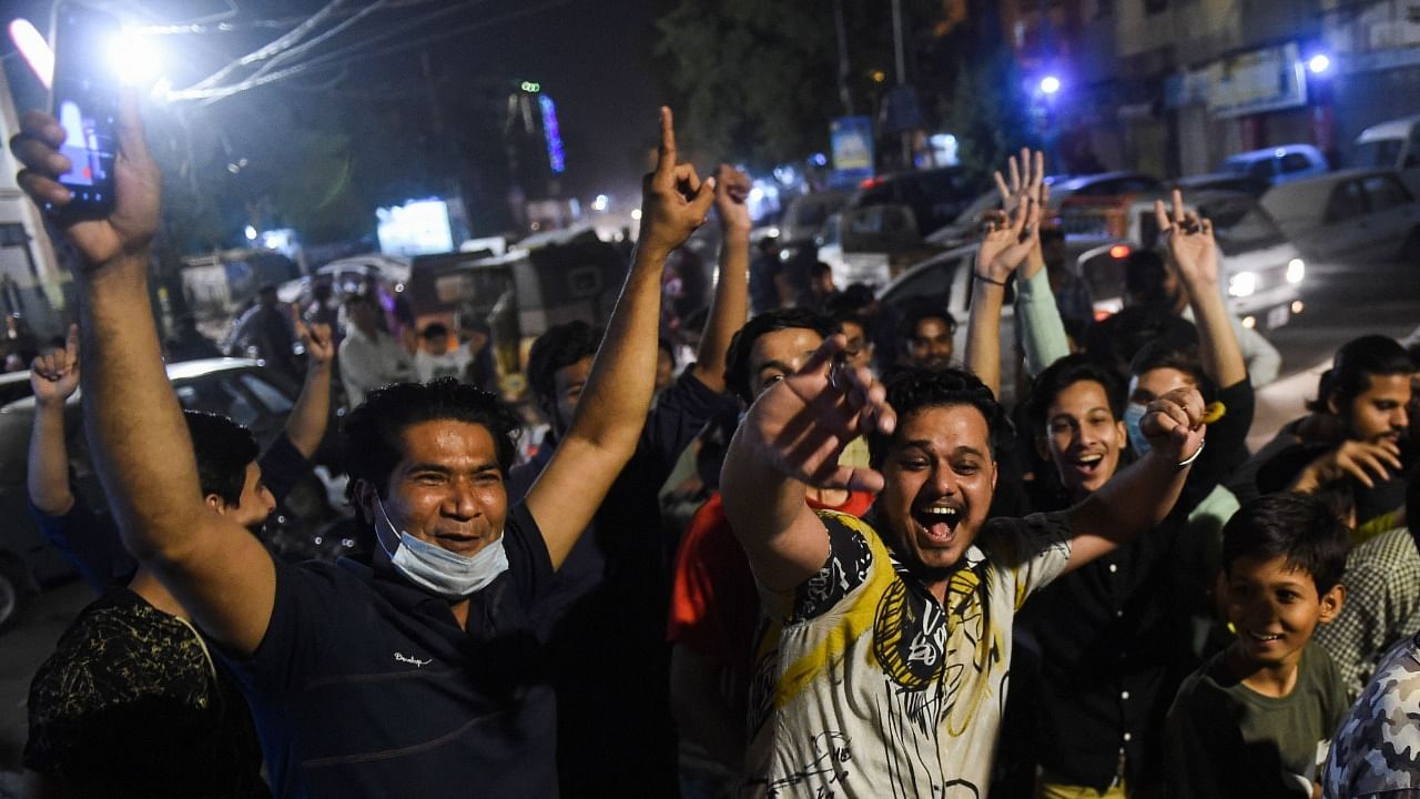 Fans in Karachi celebrate the Pakistani victory over India in the Super 12 T20 World Cup match between the teams. Credit: AFP Photo