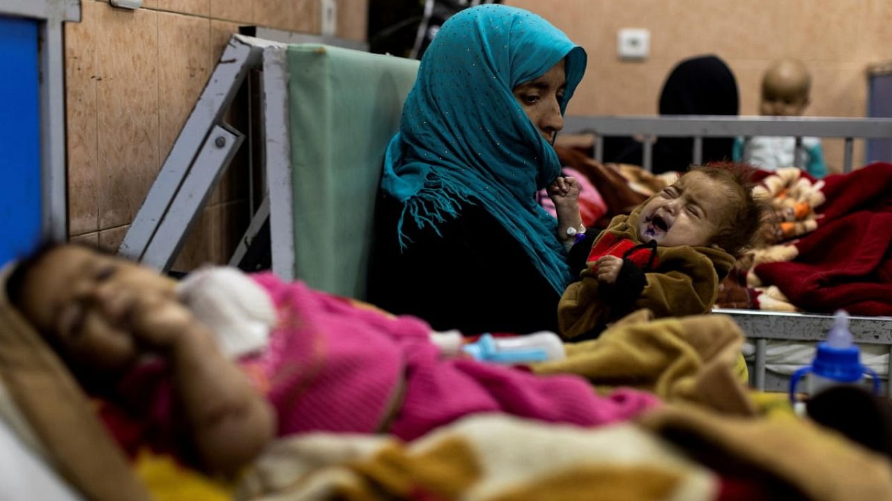 A mother holds her baby at the malnutrition ward of Indira Gandhi hospital in Kabul. Credit: Reuters Photo