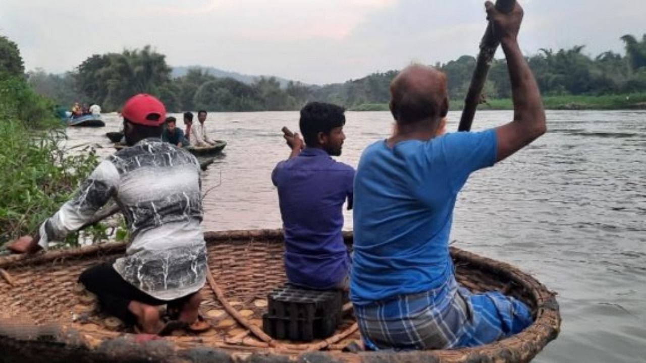 One of the teams involved in the search operation to trace Moeen Gulbarg (15), who was dragged away by a crocodile into Kali river, near Dandeli in Uttara Kannada on Sunday. Credit: DH Photo
