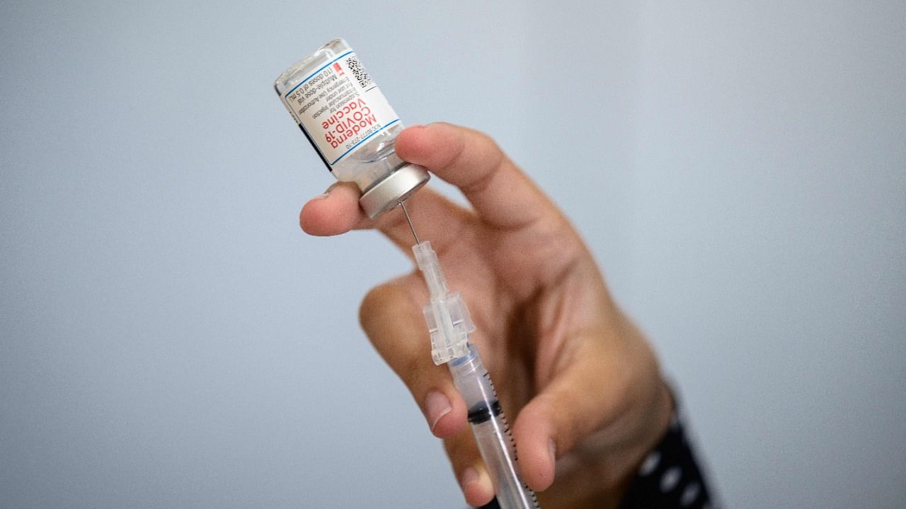 A medical staff member prepares a syringe with a vial of the Moderna Covid-19 vaccine. Credit: AFP Photo