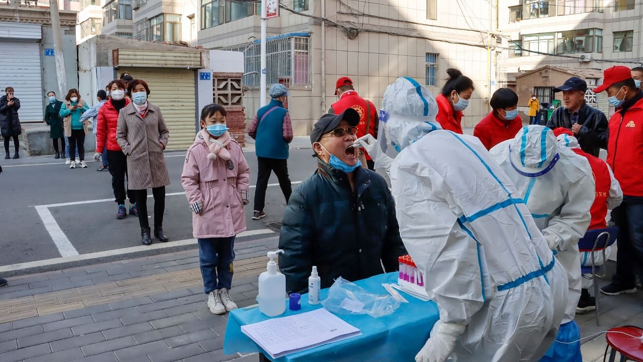 A resident undergoes a nucleic acid test for the Covid-19 coronavirus in Zhangye in China's northwestern Gansu province. Credit: AFP File Photo