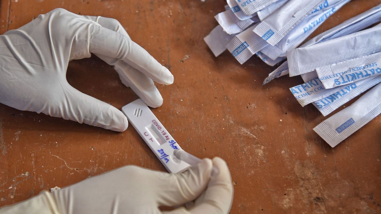 A health worker conducts a Rapid Antigen Testing (RAT) to a patient at the Kanaswadi Public Health Centre (PHC). Credit: AFP File Photo