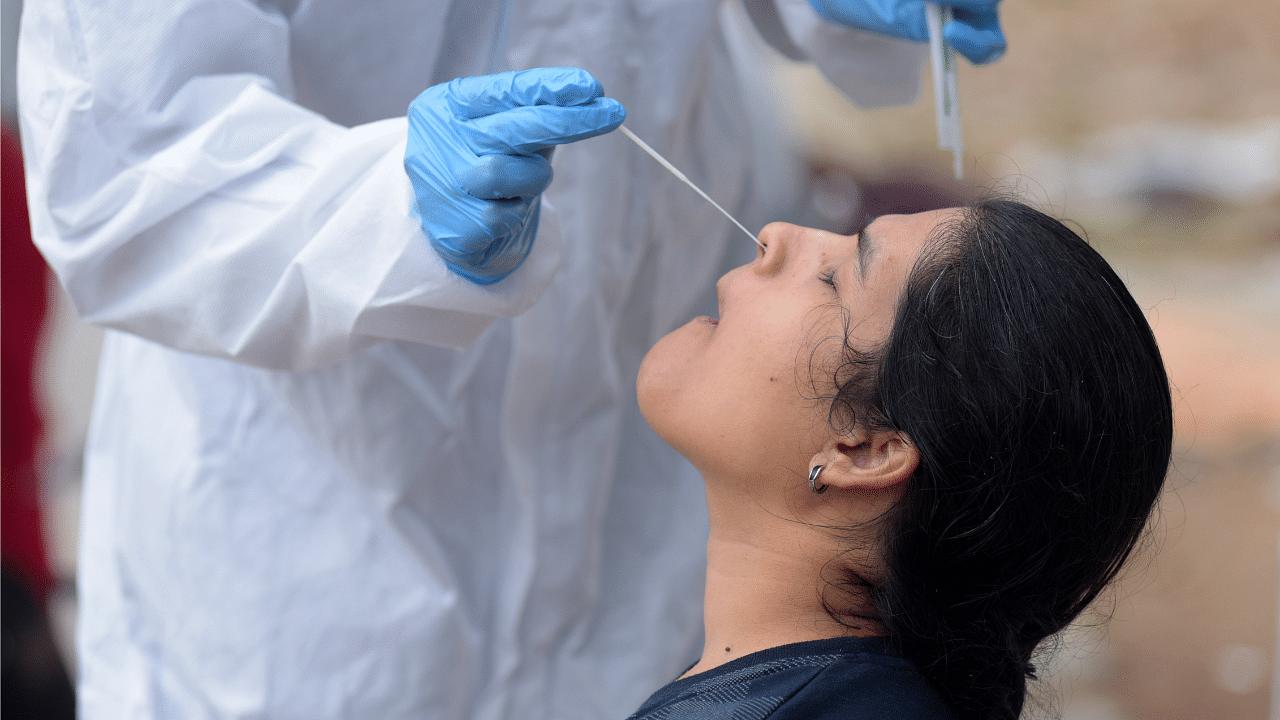 A healthcare worker collects swab samples for coronavirus. Credit: DH Photo