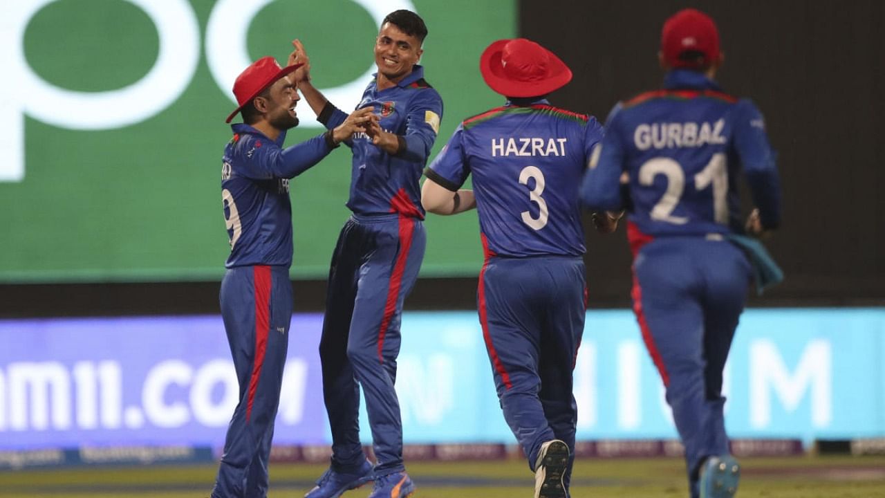 Afghanistan's Mujeeb Ur Rahman, third right, celebrates the wicket of Scotland's captain Kyle Coetzer during the Cricket Twenty20 World Cup match between Afghanistan and Scotland in Sharjah. Credit: AP/PTI photo