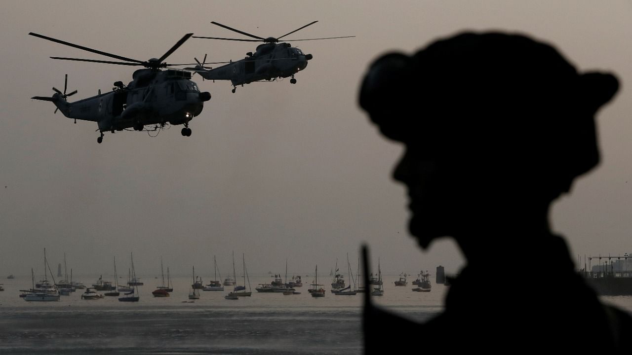 An Indian Navy marine commando watches Sea King Mk 42 ASW helicopters during a rehearsal ahead of Navy Day celebrations in Mumbai. Credit: Reuters File Photo