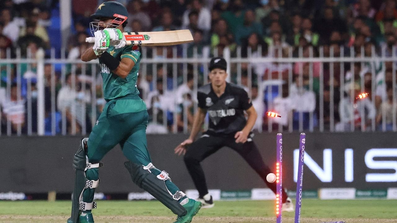 Pakistan's captain Babar Azam (L) is clean bowled by New Zealand's Tim Southee (unseen) during the ICC men’s Twenty20 World Cup cricket match between Pakistan and New Zealand at the Sharjah Cricket Stadium in Sharjah on October 26, 2021. Credit: AFP Photo