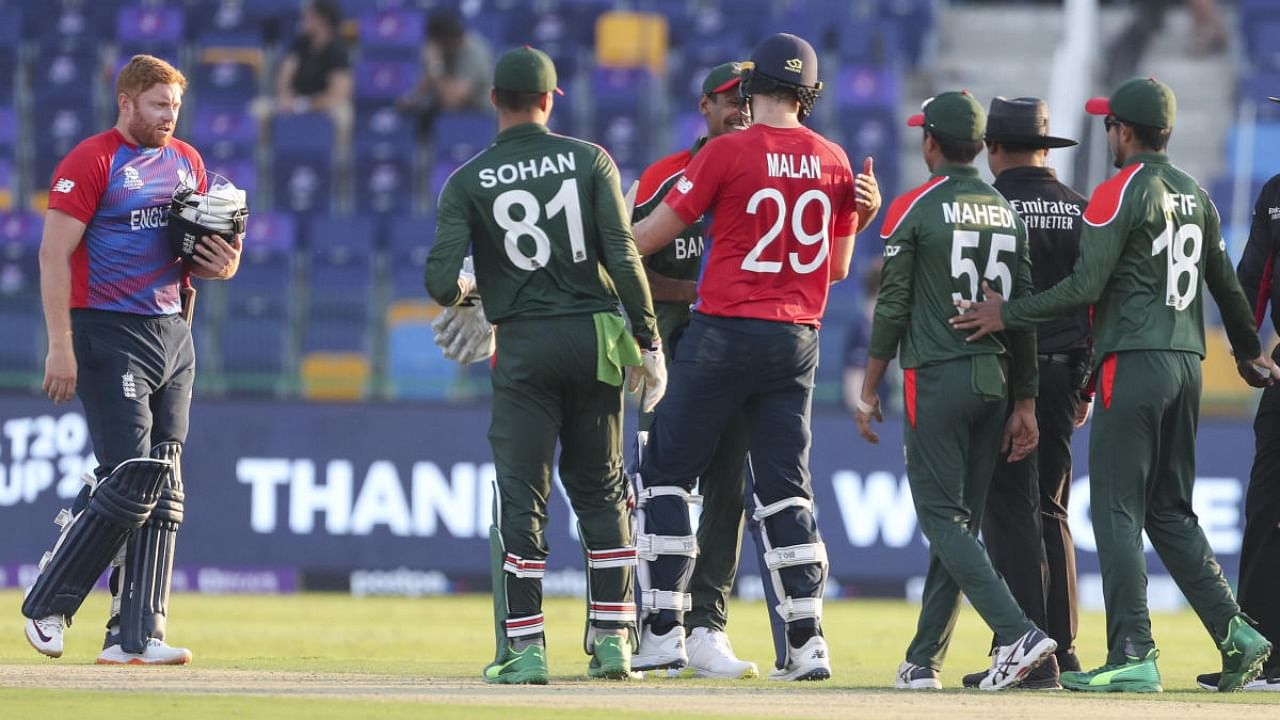 Jonny Bairstow, left, and Dawid Malan are congratulated by Bangladesh players following their eight wicket win in their Cricket Twenty20 World Cup in Abu Dhabi. Credit: AP/PTI photo