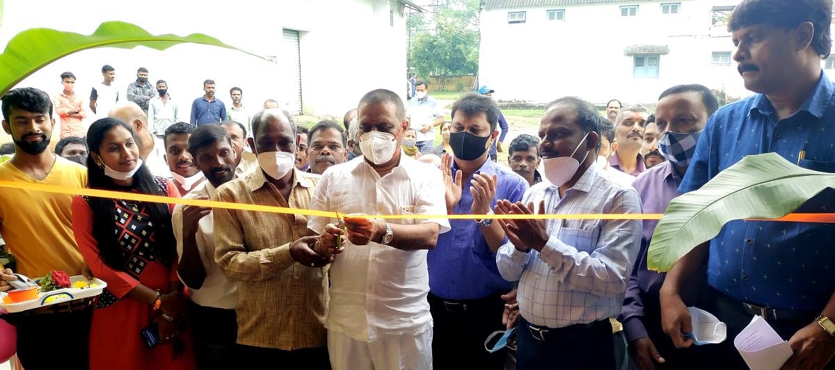 Madikeri MLA Appachu Ranjan inaugurates a warehouse on the premises of the Lamps society in Basavanahalli on Tuesday.