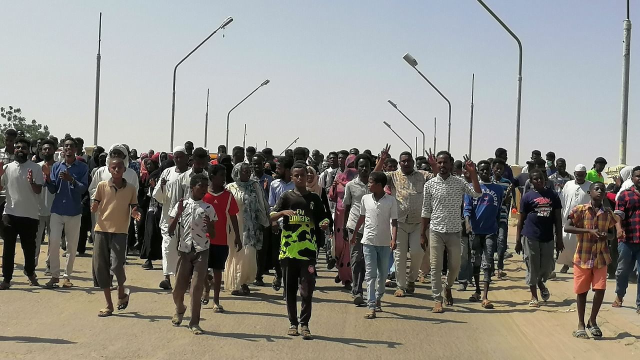 Sudanese demonstrators march and chant during a protest against the military takeover, in Atbara. Credit: Reuters Photo