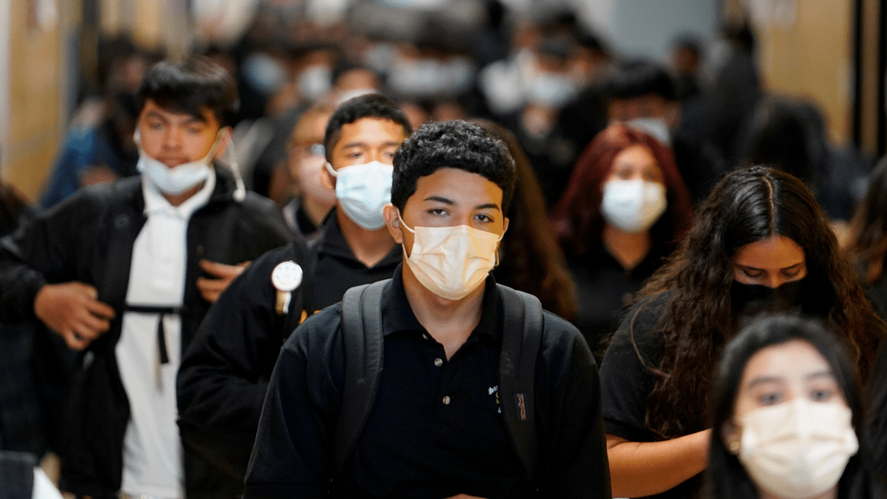Students wear masks while walking to class to prevent the spread of the coronavirus disease. Credit: Reuters Photo