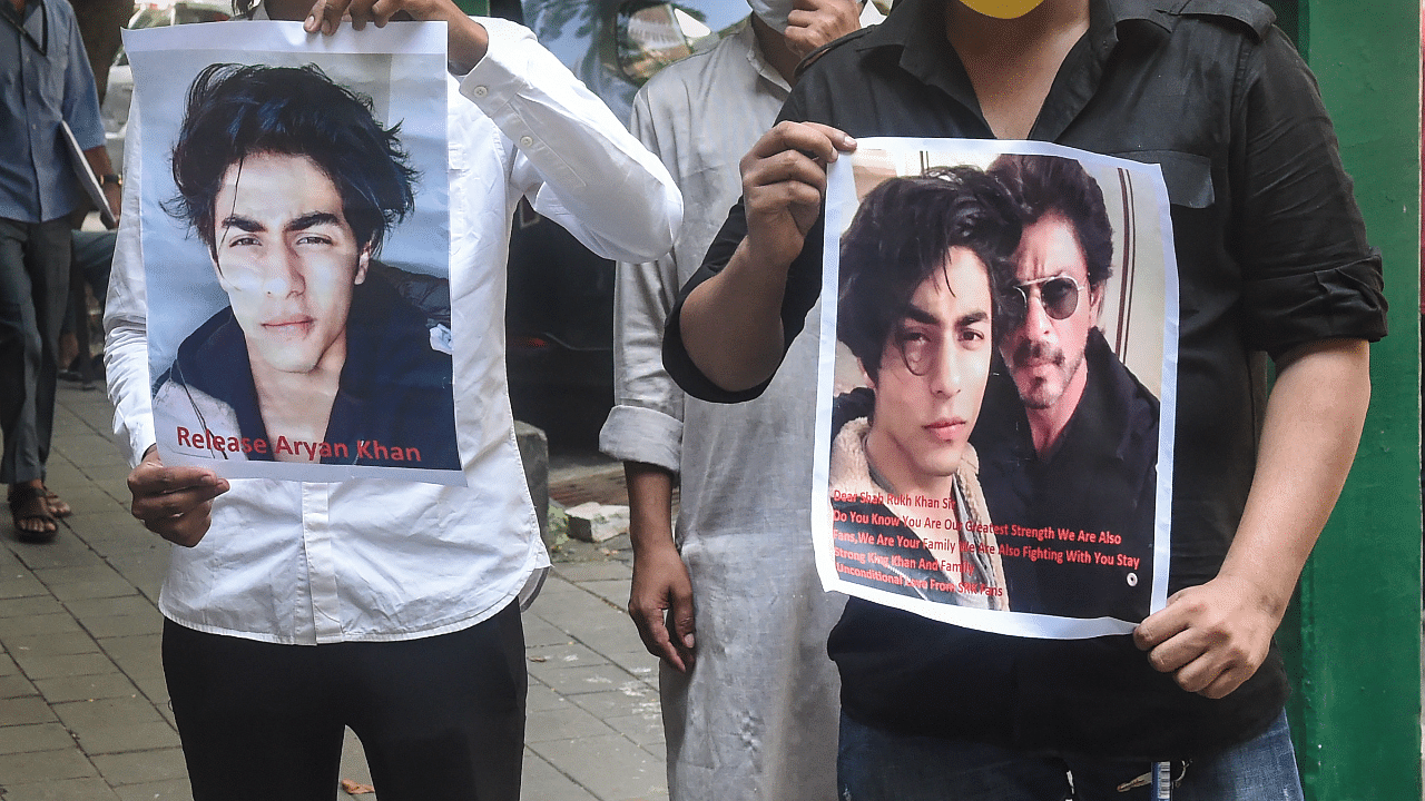 Fan's of Bollywood actor Shah Rukh Khan, hold posters written with 'Release Aryan Khan' stand outside Bombay High court. Credit: PTI Photo