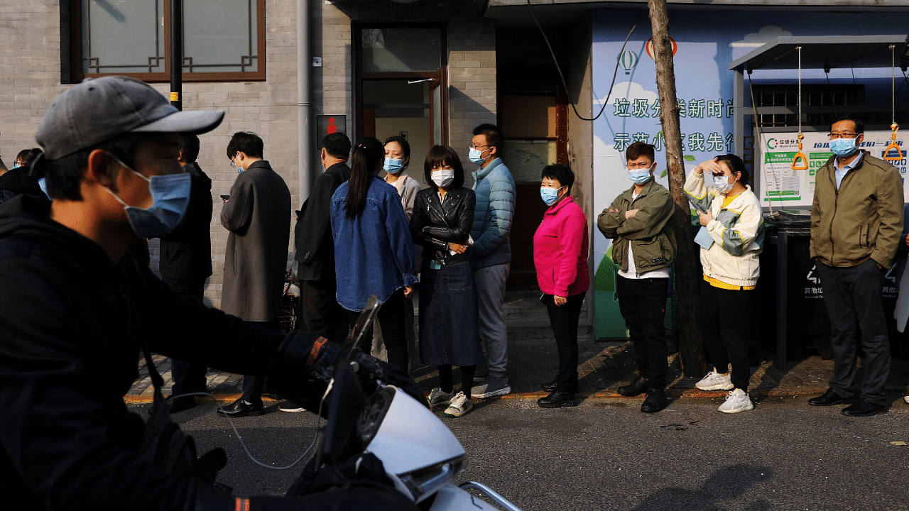 People line up outside a vaccination site after the city started offering booster shots of the vaccine against the coronavirus. Credit: Reuters Photo