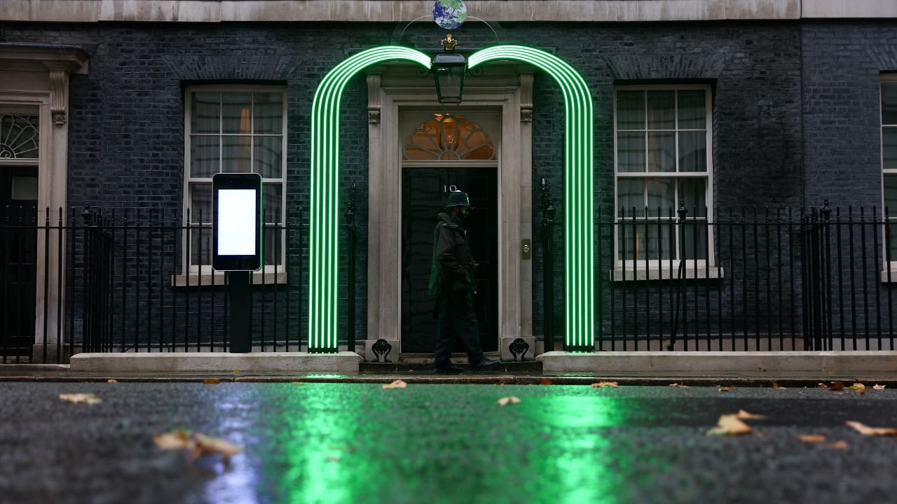 Green light installation is illuminated outside Number 10 Downing Street ahead of the UN Climate Change Conference (COP26) taking place in Glasgow, in London. Credit: Reuters Photo