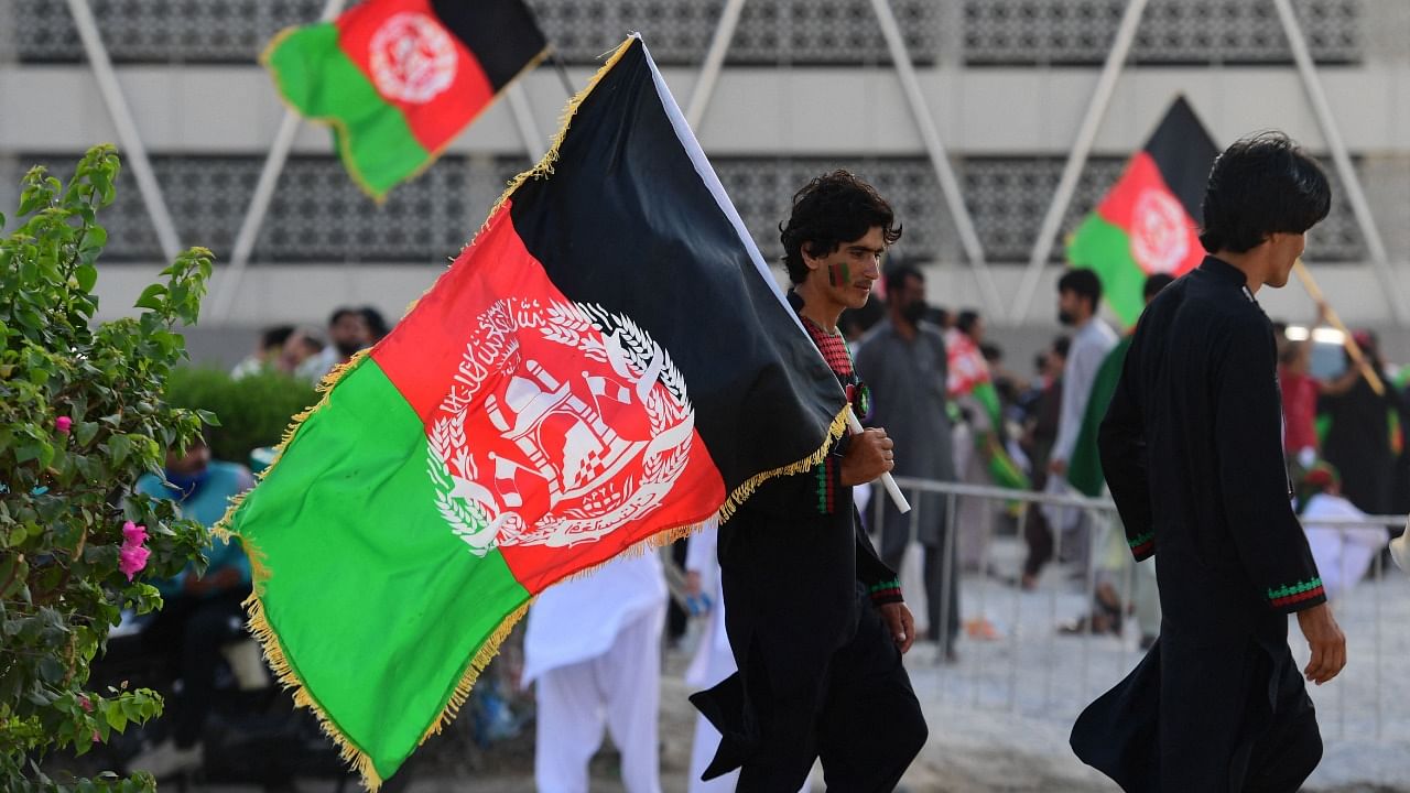 Fans of Afghanistan's team arrive to watch the T20 World Cup match between Afghanistan and Pakistan at the Dubai International Cricket Stadium. Credit: AFP File Photo