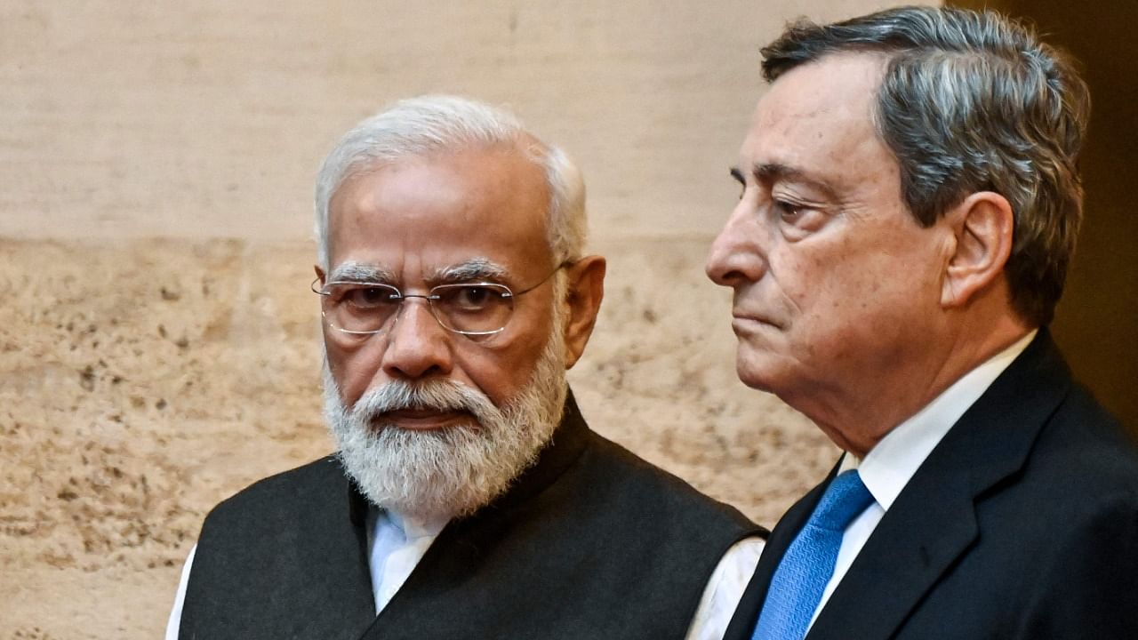 Italy's Prime Minister, Mario Draghi (R) greets Indian Prime Minister Narendra Modi upon his arrival for their meeting at the Chigi palace in Rome on October 29, 2021, ahead of an upcoming G20 summit of world leaders to discuss climate change, Covid-19 and the post-pandemic global recovery. Credit: AFP Photo
