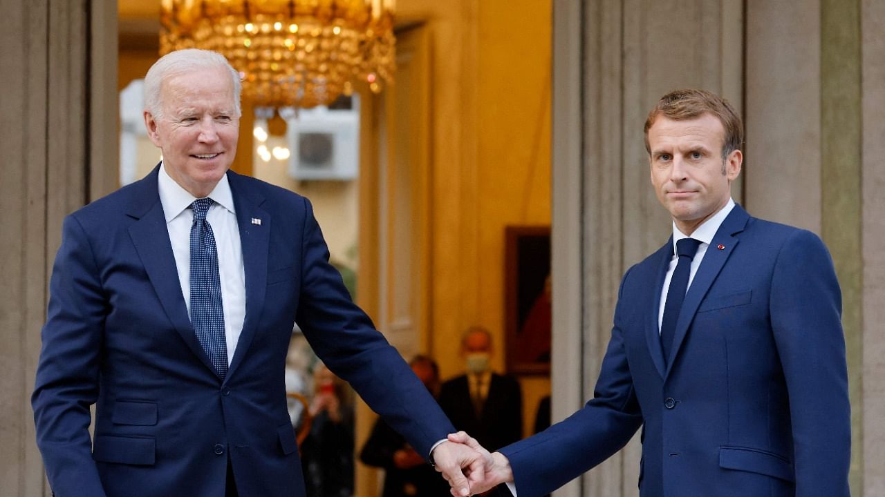 French President Emmanuel Macron (R) welcomes US President Joe Biden (L) before their meeting at the French Embassy to the Vatican in Rome. Credit: AFP Photo